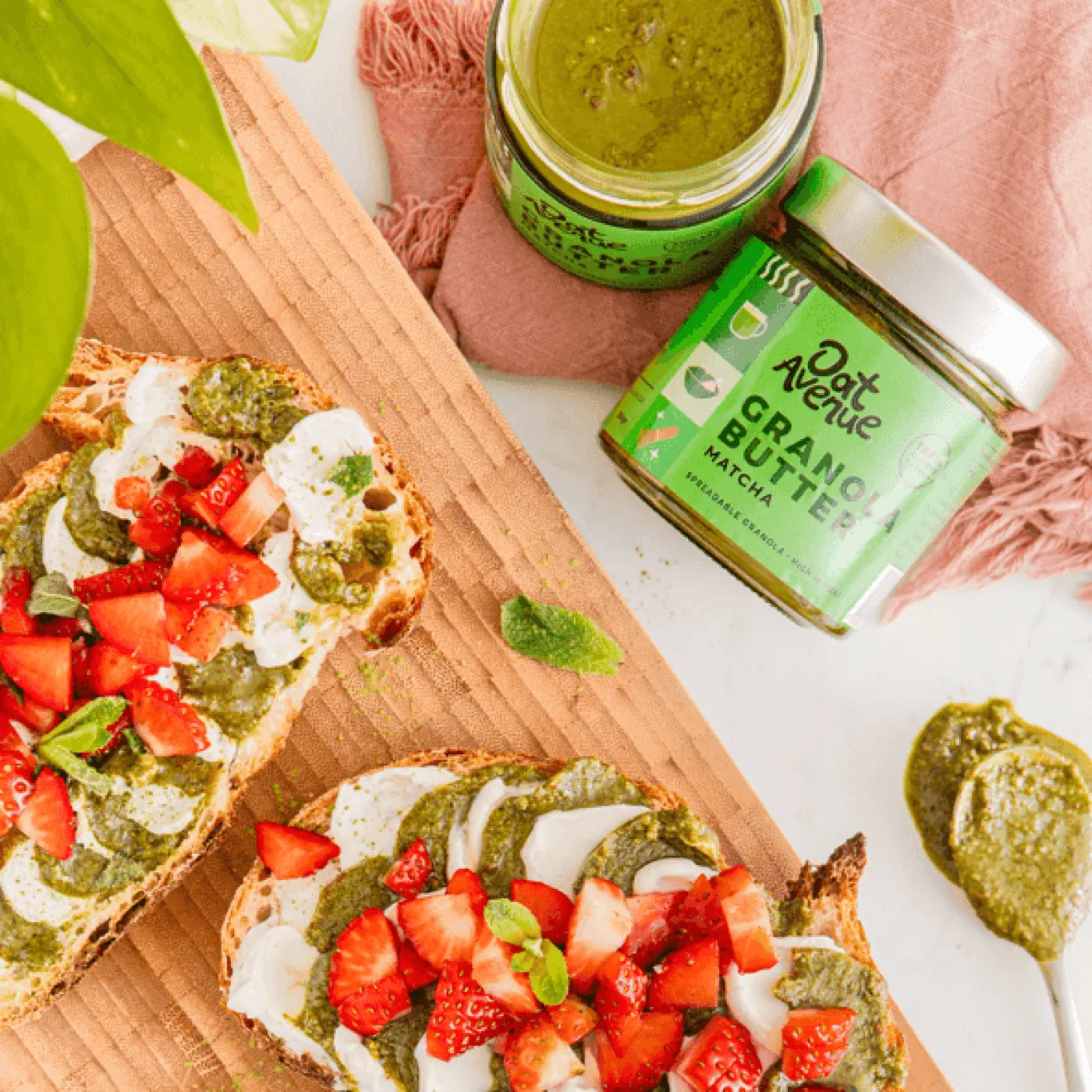 Toast topped with Matcha granola butter and sliced strawberries